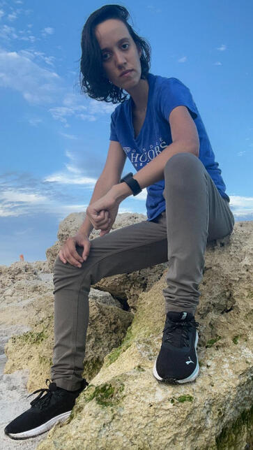 Purple Triangular logo with a teal ribbon on top. Inside the rectangular teal ribbon is the word "Specialist" in all white capitalized font. Underneath the word "Specialist", next to the triangular logo, is the word "Certified" in purple and all caps. The